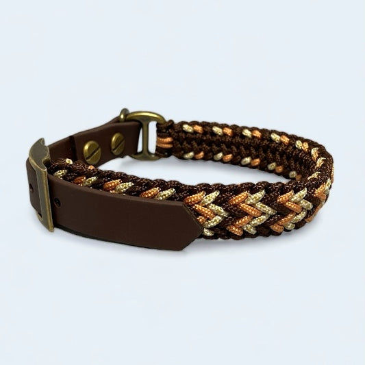 Paracord collar for tiny dogs in brown and gold colours placed on a light background.